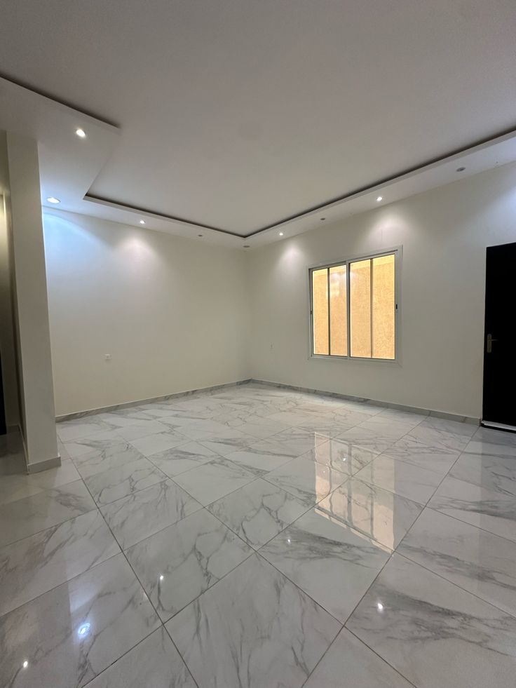 Yeni boyanmış geniş salon, mermer görünümlü zemin ve spotlu asma tavan